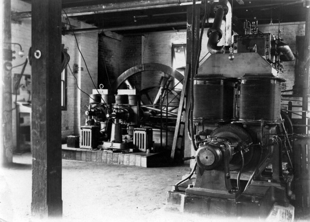The plant comprised three Robey cross-compound horizontal, non-condensing steam engines, each belt driving a 300 kW, 550-volt direct current (DC) generator. Each belt was ninety feet long and three feet wide. There were four hand-fed boilers working at 150 pounds per square inch of pressure to provide steam to the engines.